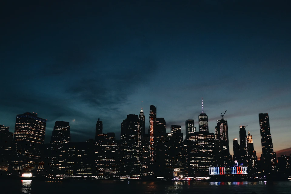 Office towers lit up against the night sky