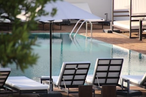 An inviting swimming pool surrounded by lounge chairs.