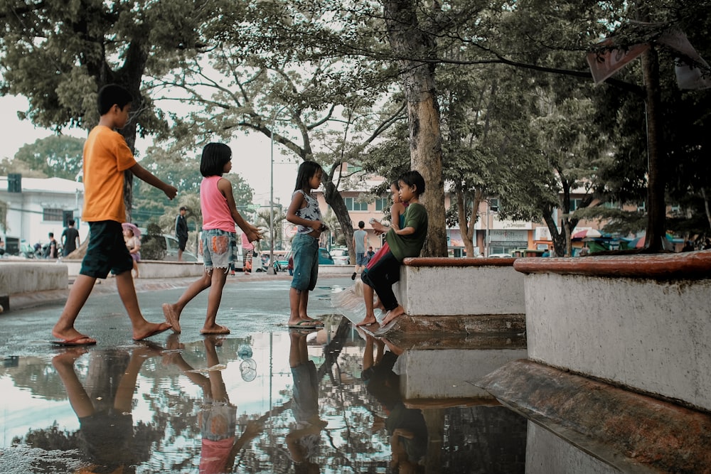 children under green leafed trees