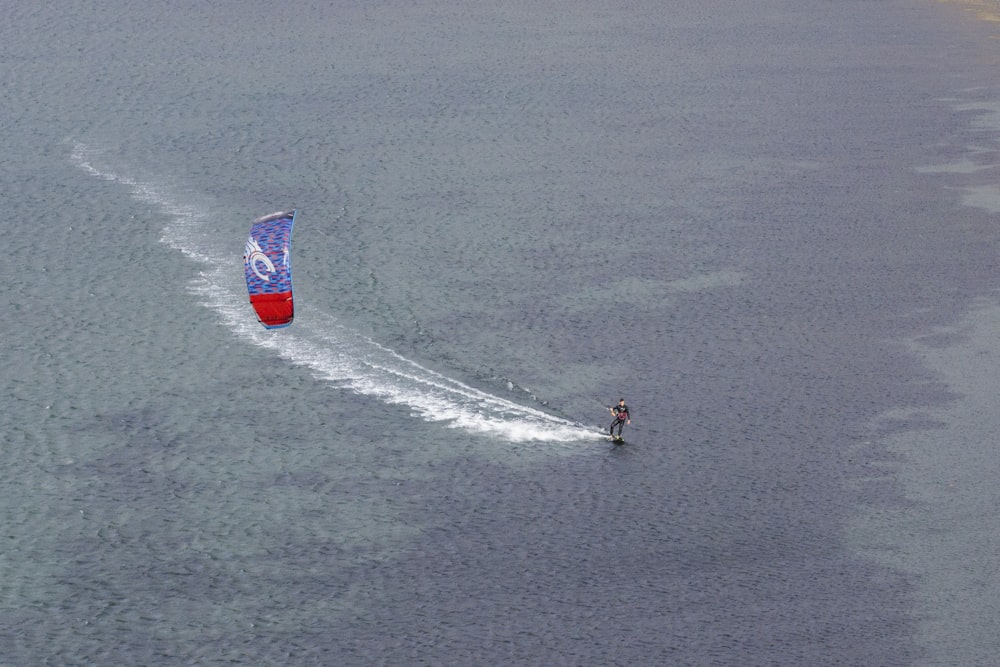 aerial photography unknown person water paragliding