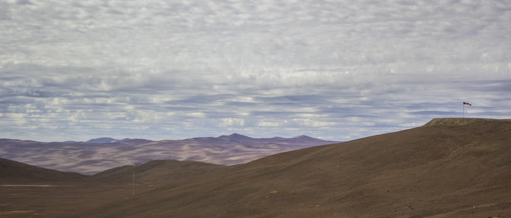 brown mountains and white clouds