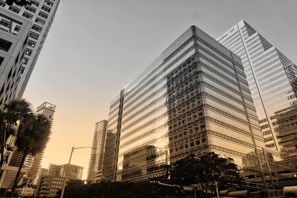 A modern cityscape at sunset showcasing smart green technology and renewable energy solutions.