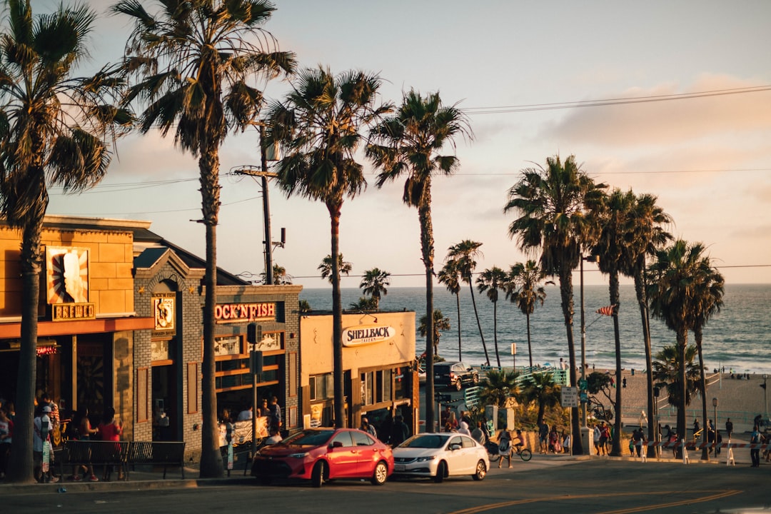 vehicles parked near tree and building, The sun setting on Manhattan Beach, California.<p></figure>If you find my photos useful, please consider subscribing to me on YouTube for the occasional photography tutorial and much more - https://bit.ly/3smVlKp - I