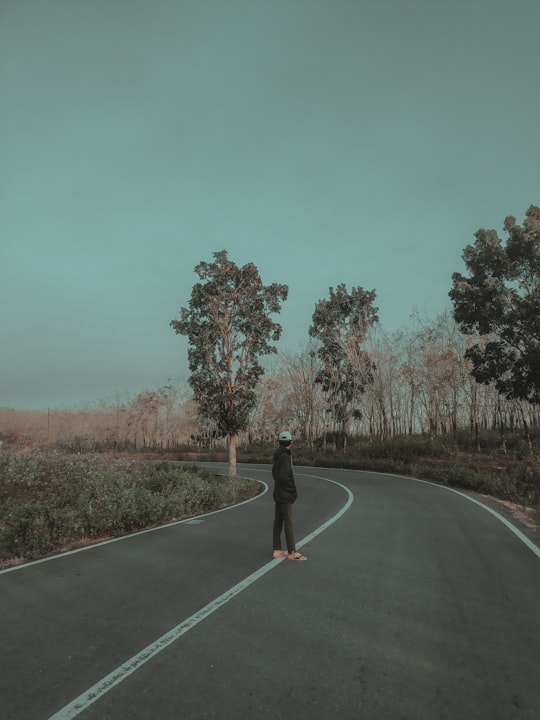 man standing on gray top road in Garut Indonesia