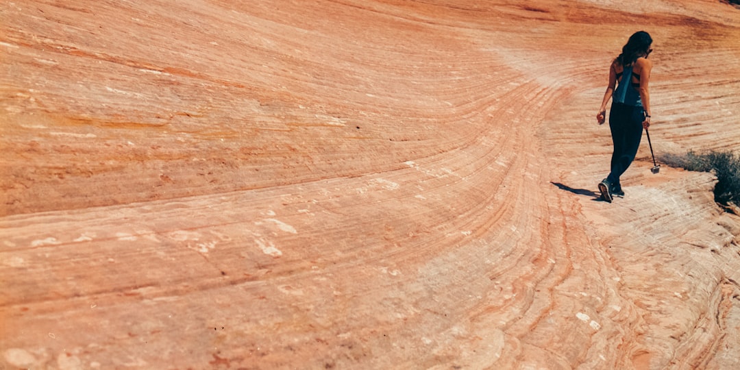 woman in black leggings walking on dirt road