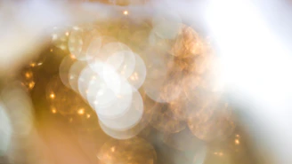 Blurred cover featuring abstract golden light patterns.