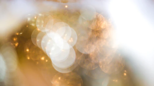 Blurred cover featuring abstract golden light patterns.