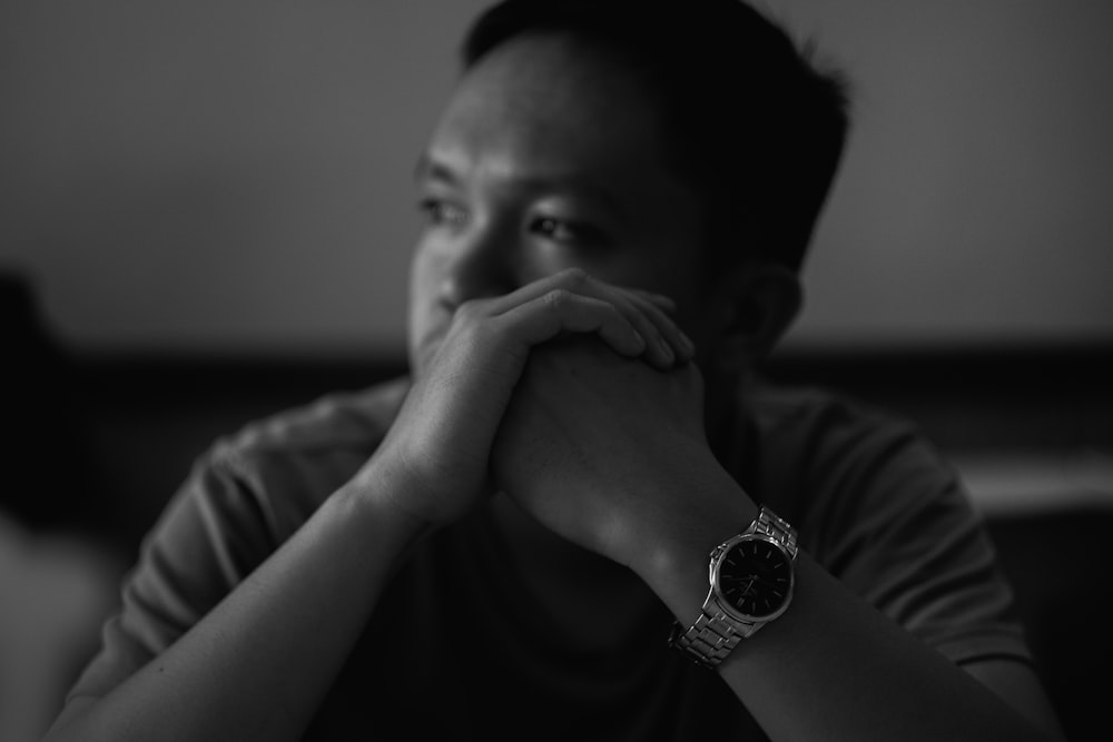 man wearing round gold-colored watch