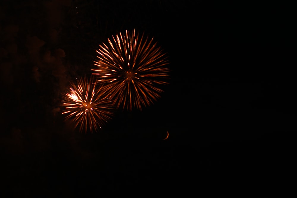 low-angle photography of red fireworks display