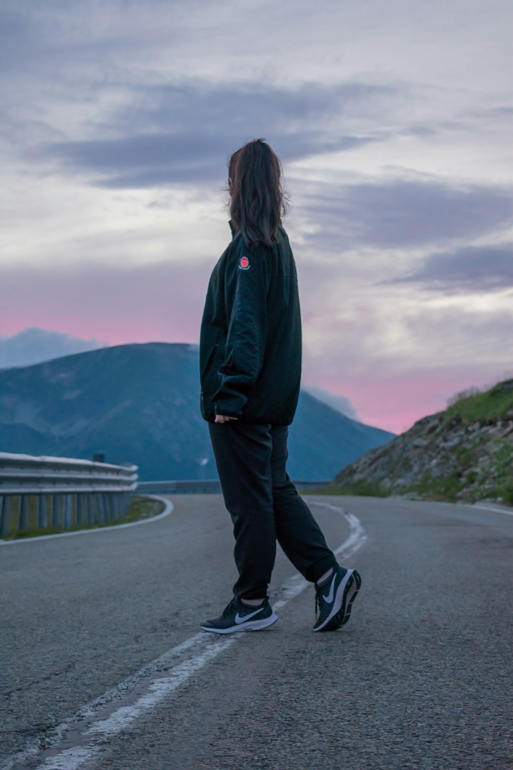 woman standing in the middle of road