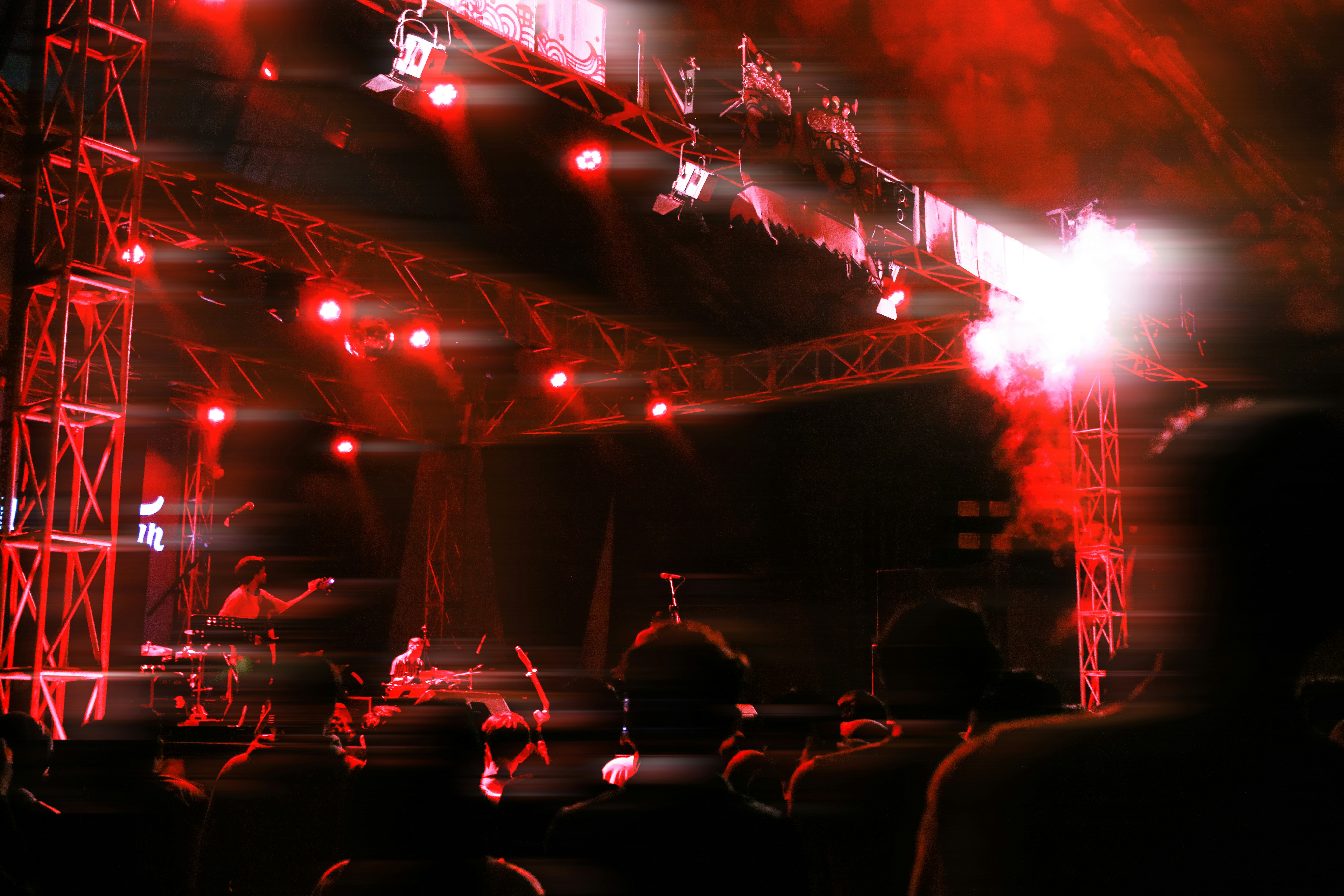 Intense concert stage with technical lighting rigs and smoke for technical death metal performance