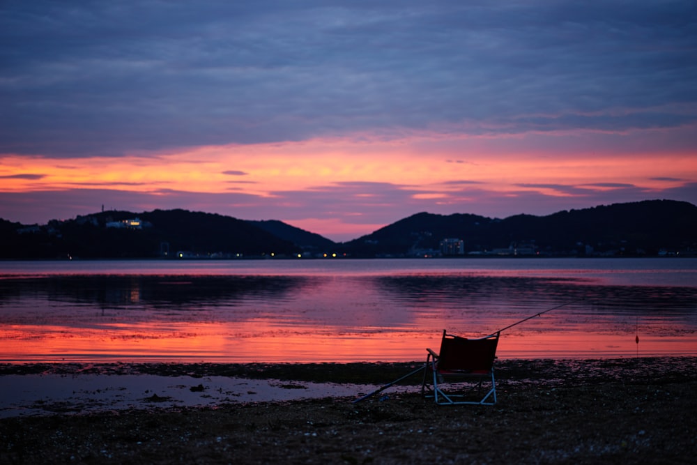 lounge chair at the shore during sunset