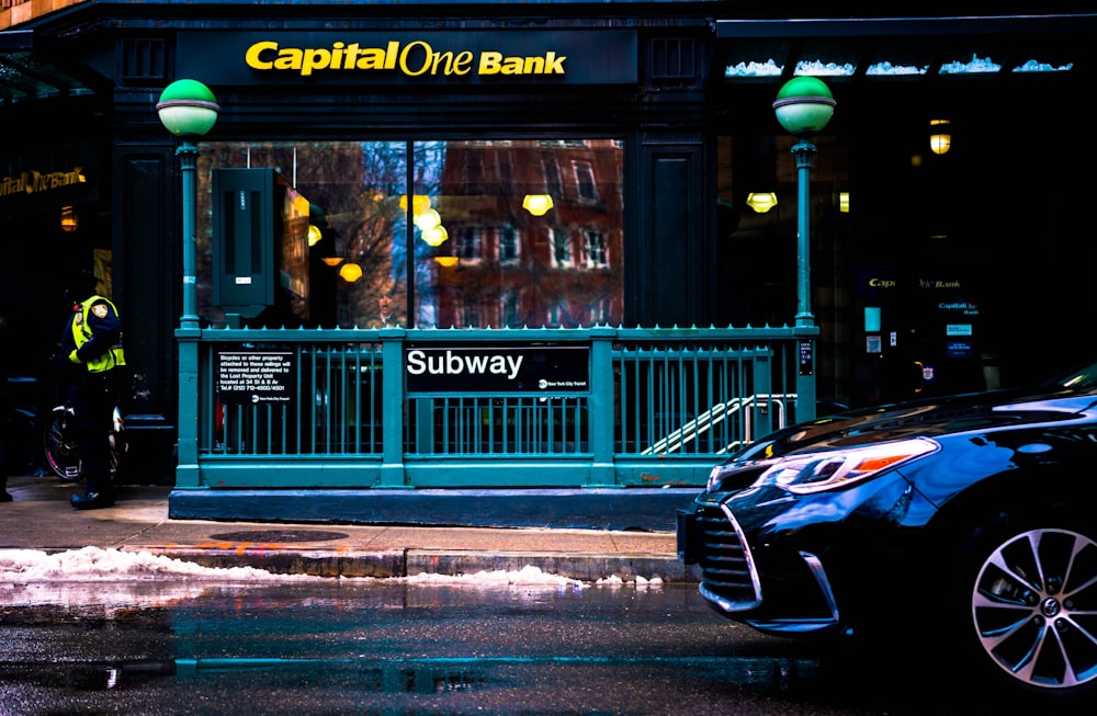 a car is parked in front of a bank