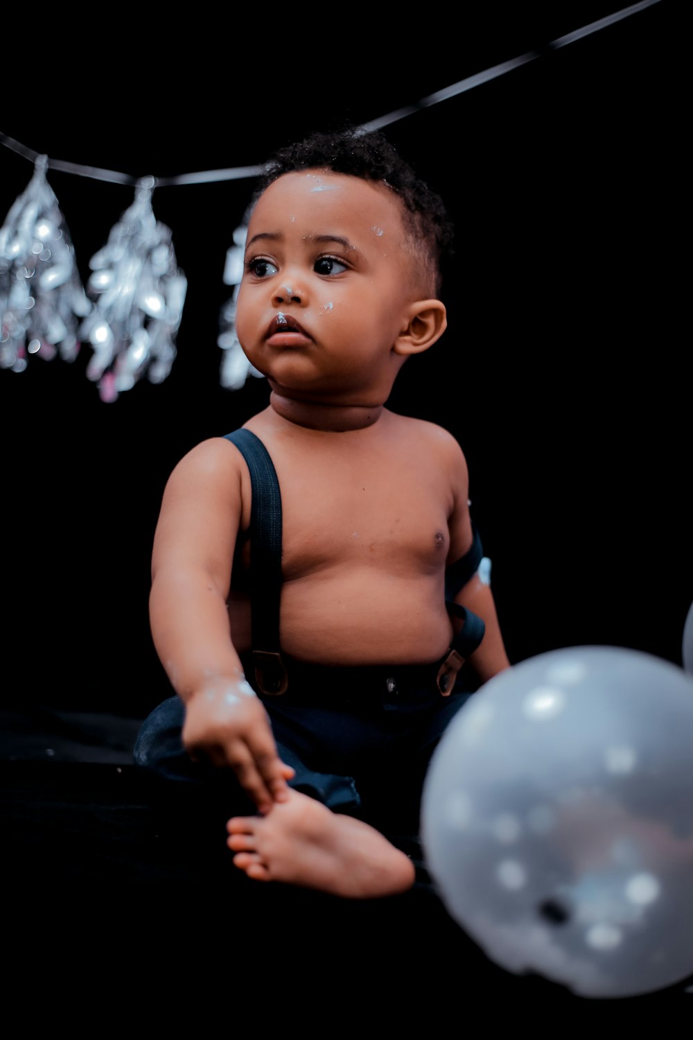 boy sitting on black floor