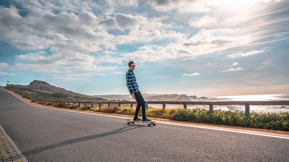 man skateboarding on road