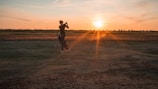 A close-up of a golfer's swing at sunset on the course.