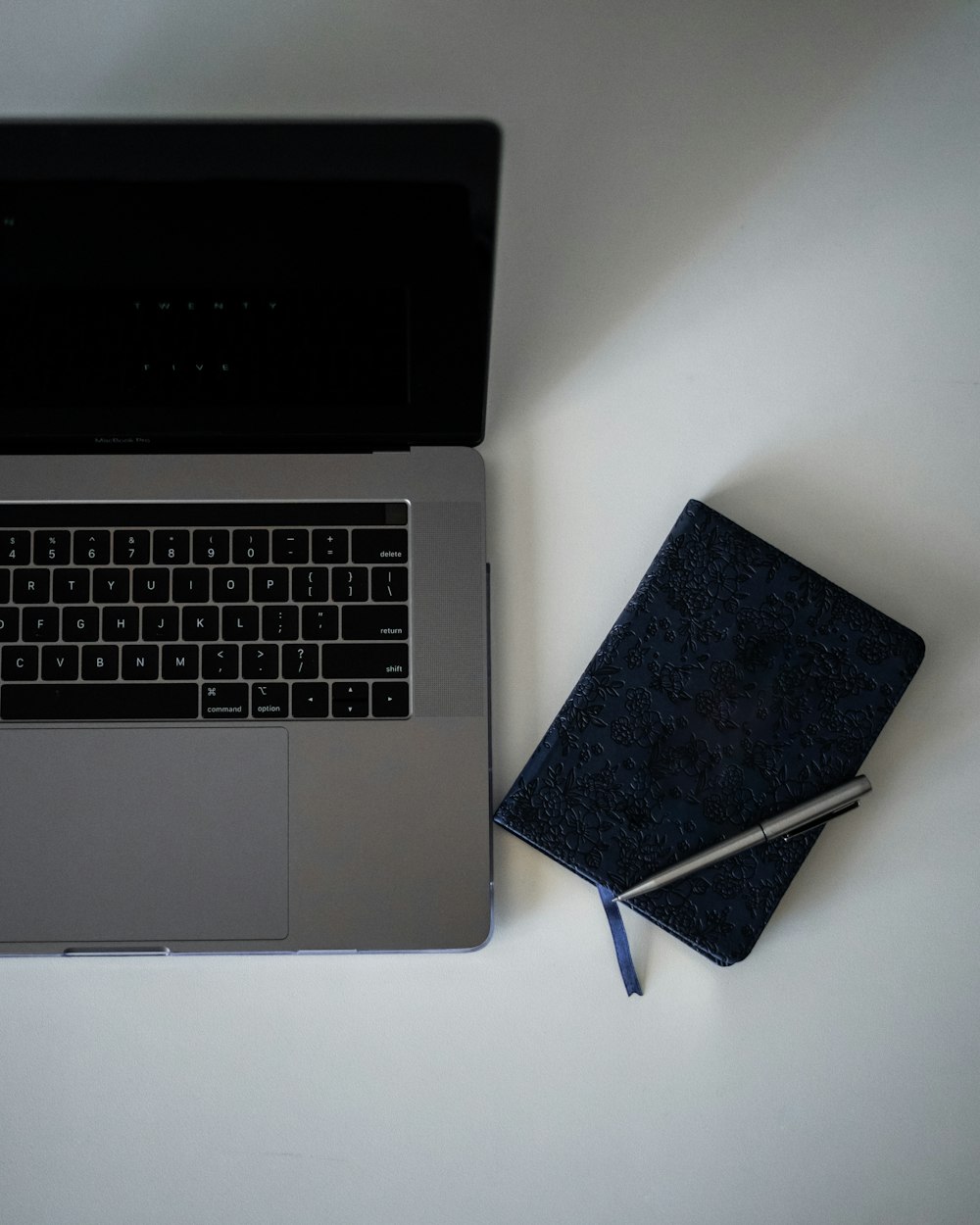 book beside laptop computer