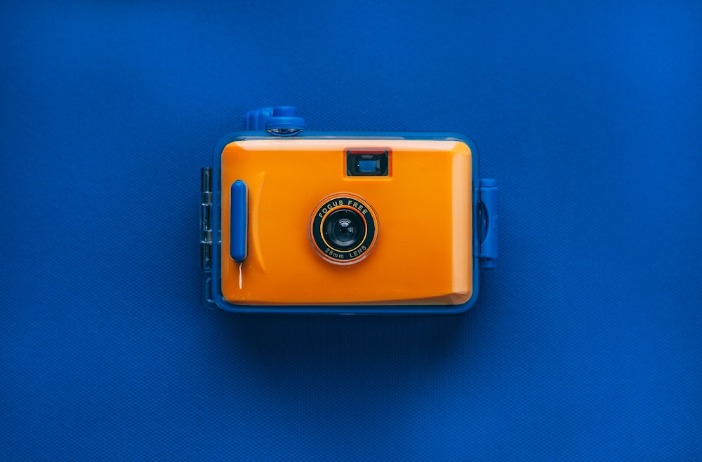 orange and black digital camera