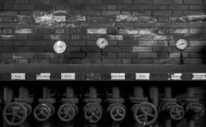 Close-up of industrial gas valves and gauges with blue-gray tones