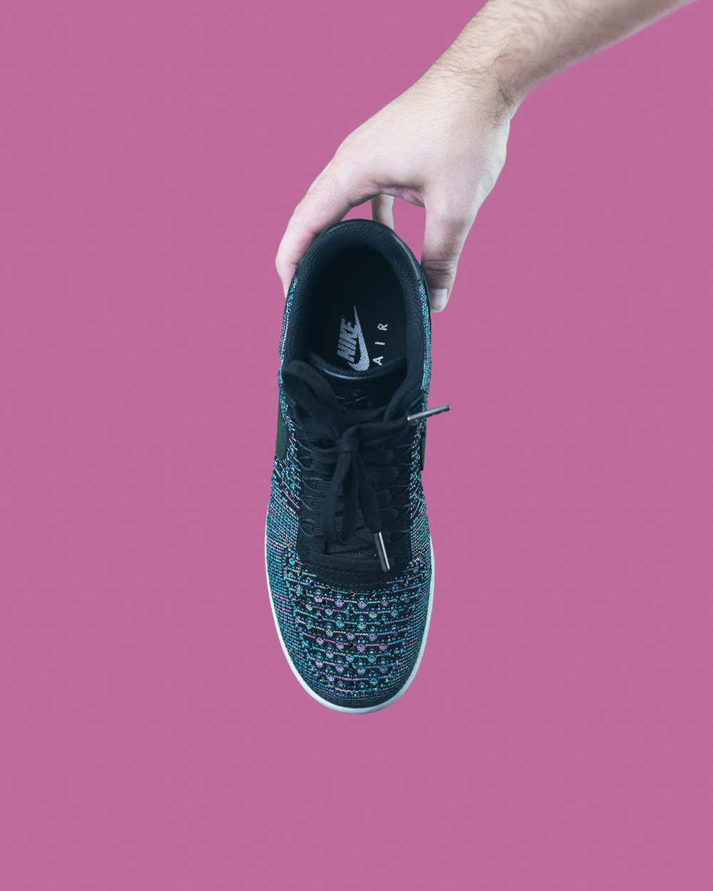 unpaired black Nike sneaker