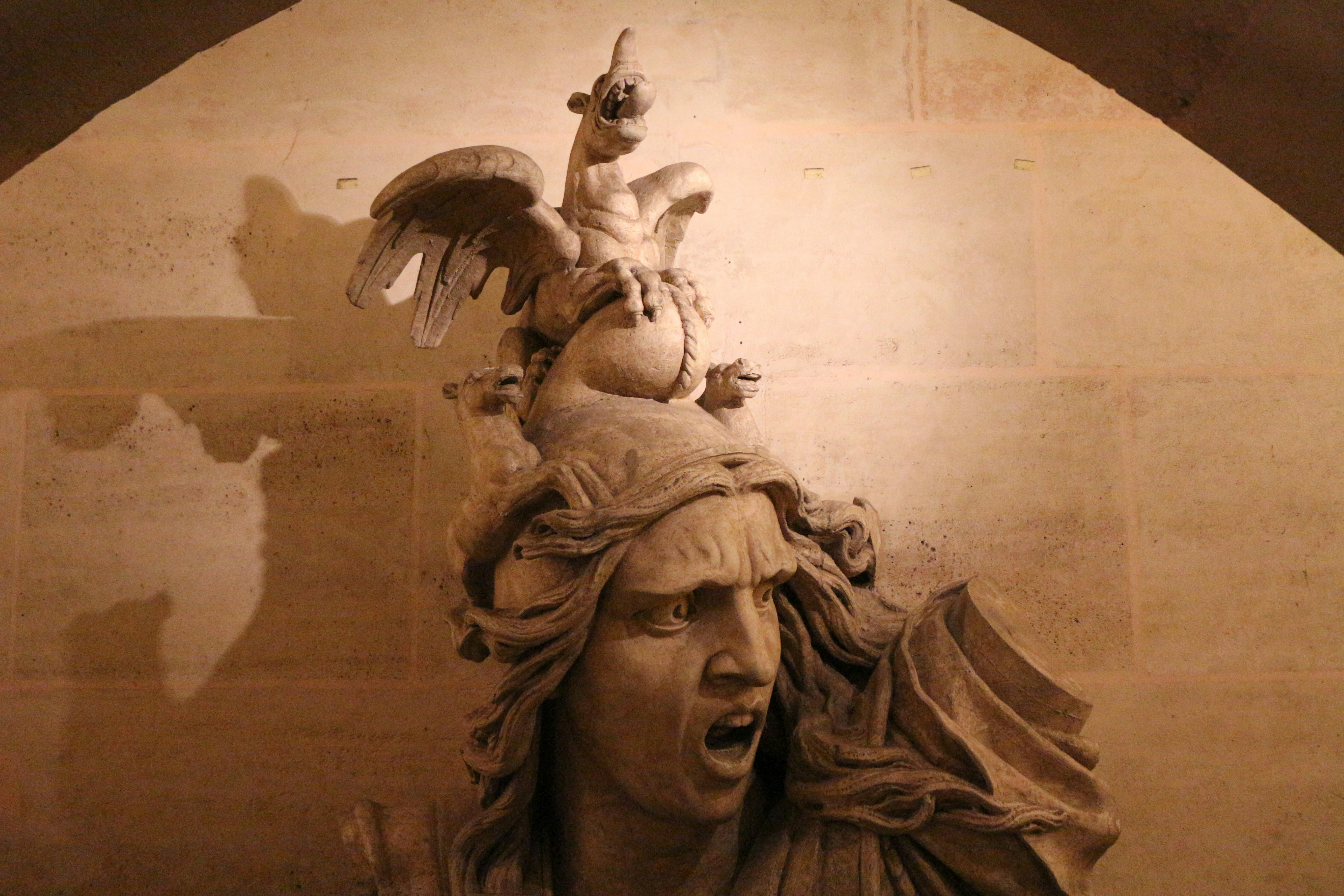 a statue of a man with a bird on his head