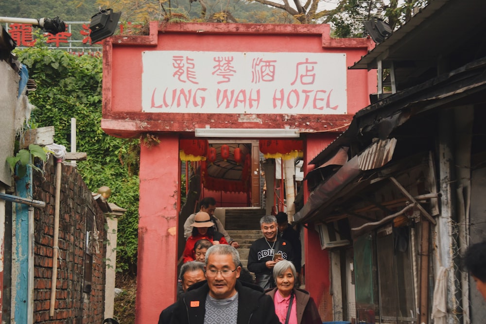 people walking out front lung wah hotel