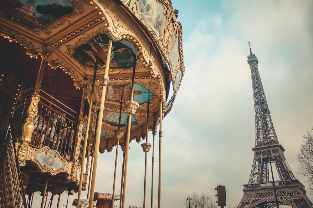 a carousel in front of the eiffel tower