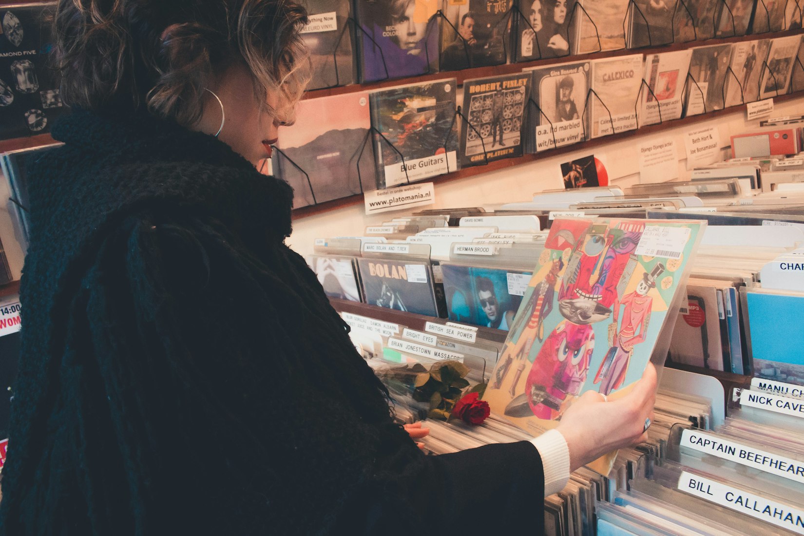 Girl holding record in record store