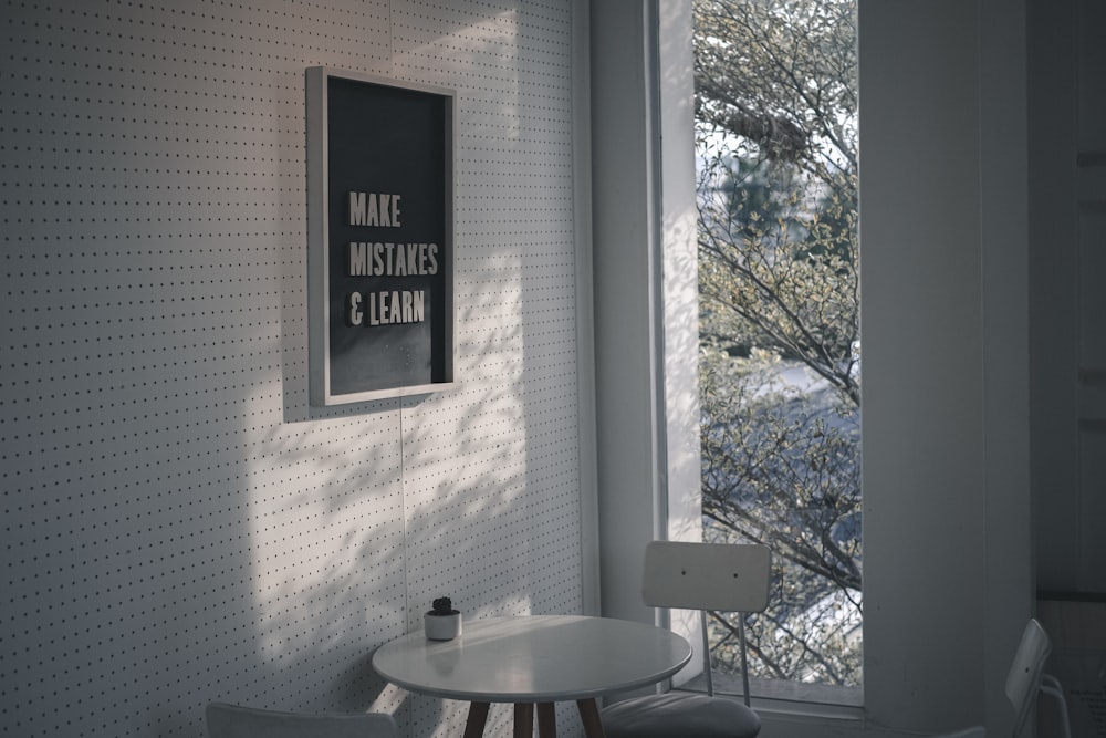 dining table and chairs beside a wall