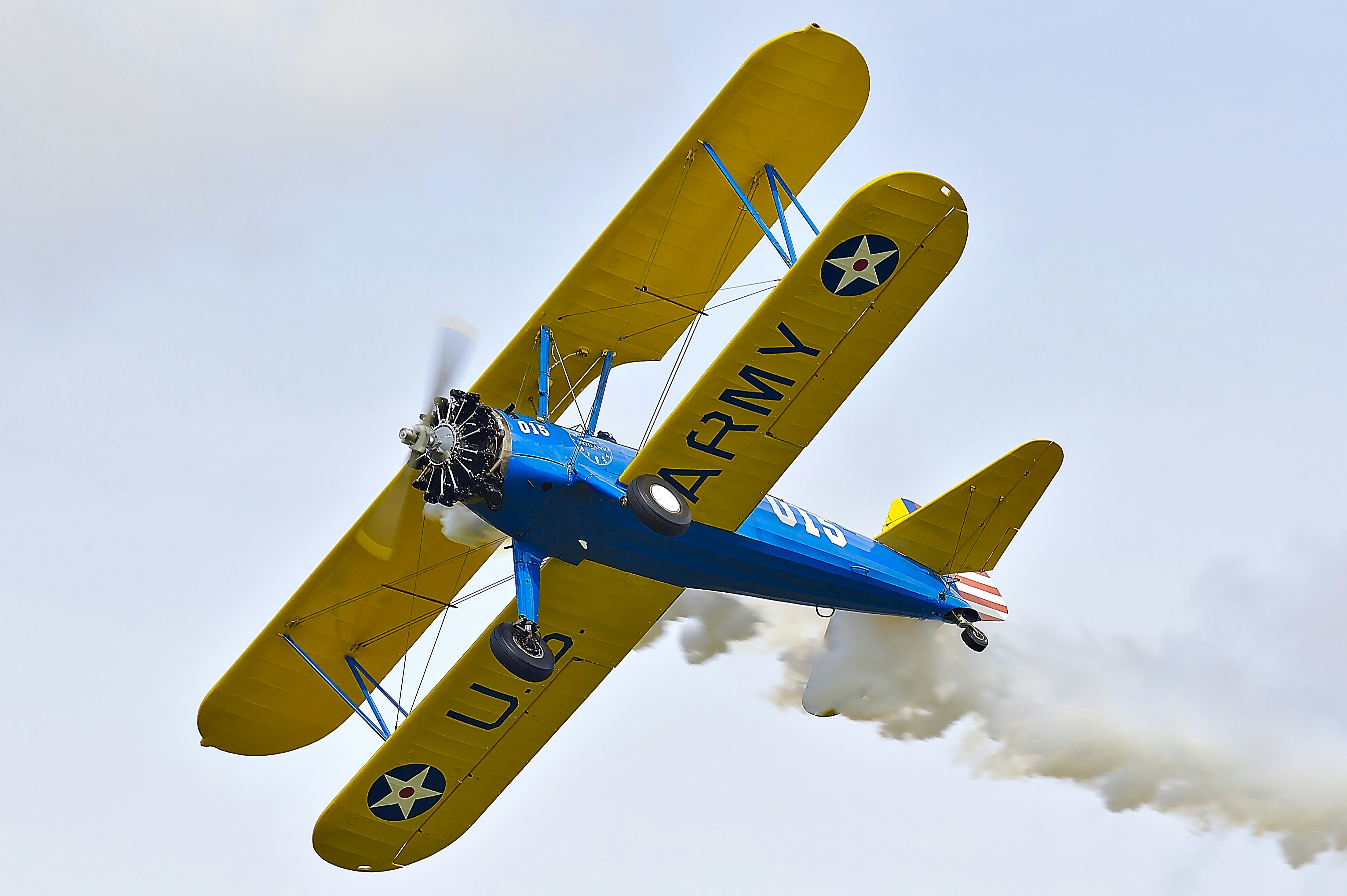 blue and yellow plane, Stearman PT-17 airplane