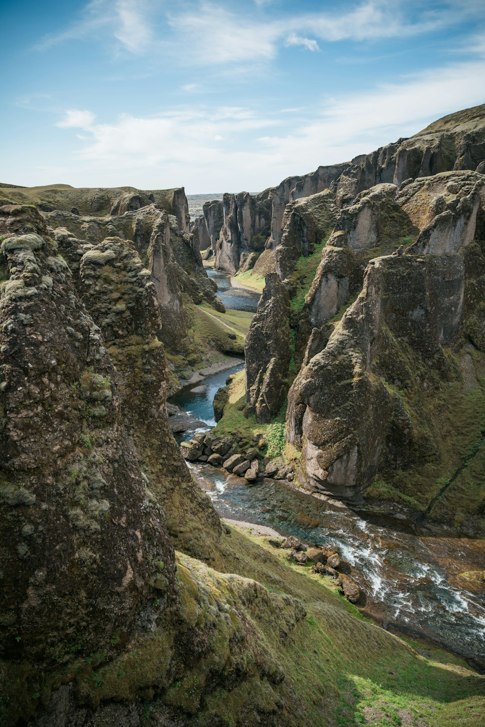 body of water in between rock formation during daytime