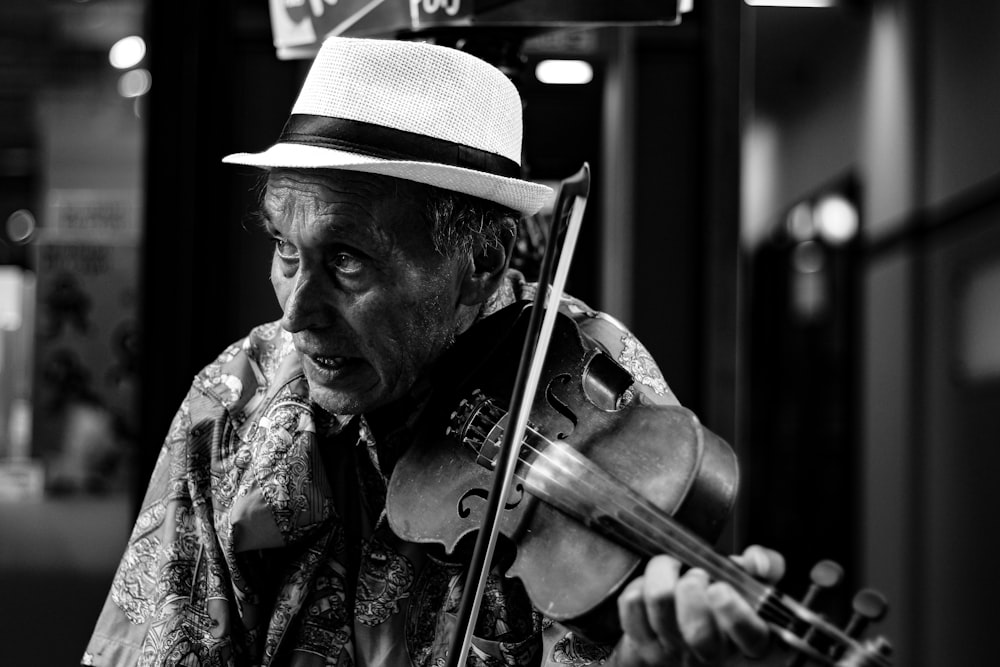 man playing violin in building