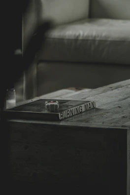 Cover art of the author's latest book displayed on a wooden table.