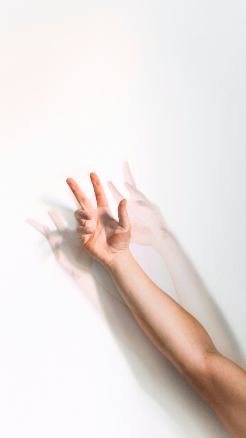 a person's hand reaching up into the air