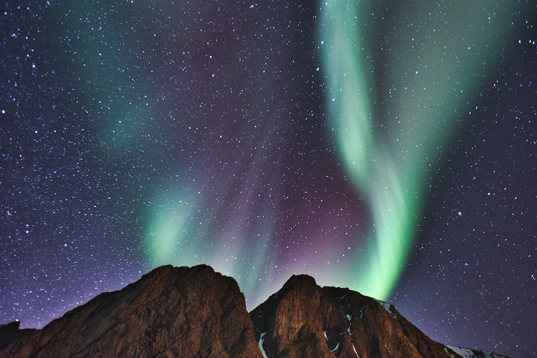 a couple of mountains that have some lights on them,