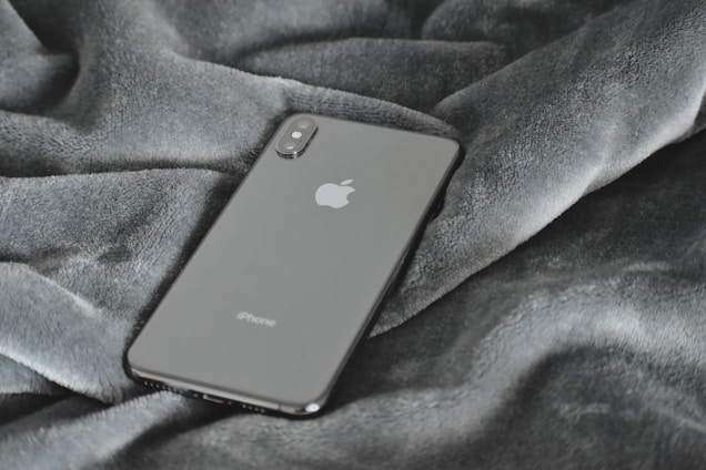 A sleek smartphone displayed on a minimalist surface with soft lighting.