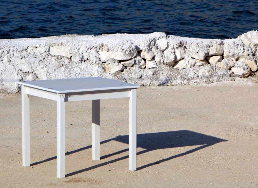 square white wooden table on dirt ground