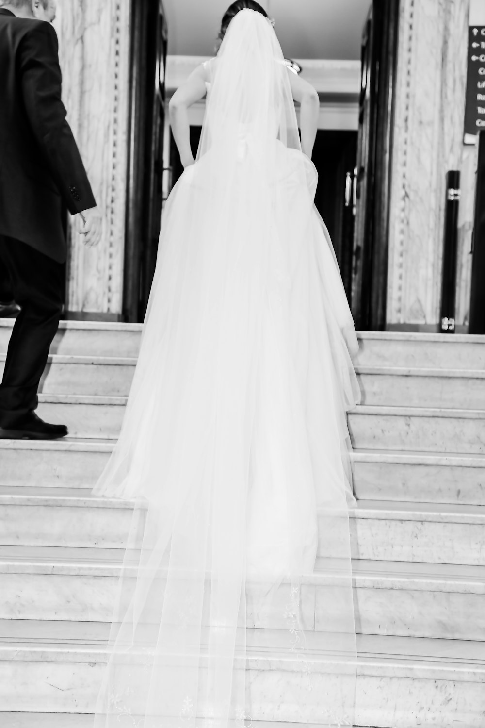 woman in wedding dress waking on stairs