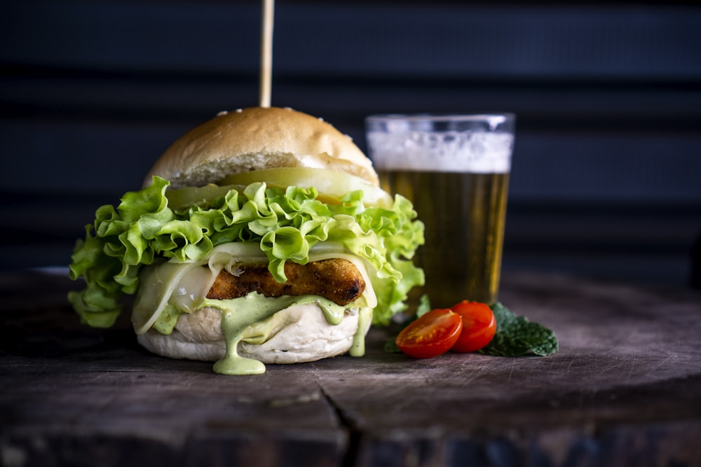 burger with sliced vegetable and white cream close-up photography