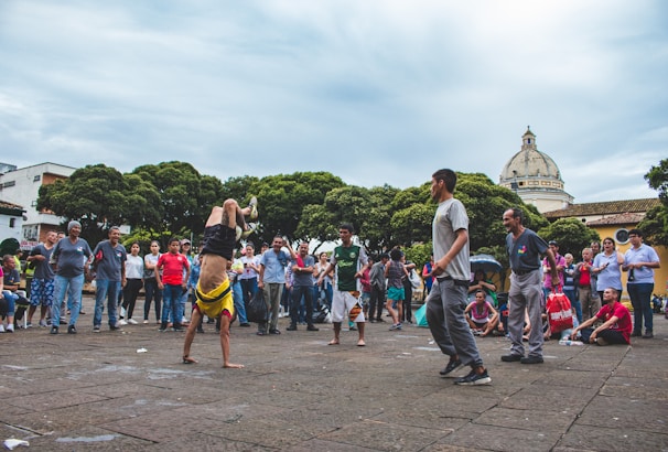 A lively acrobatics performance captivating a crowd of children and parents at a family day out.