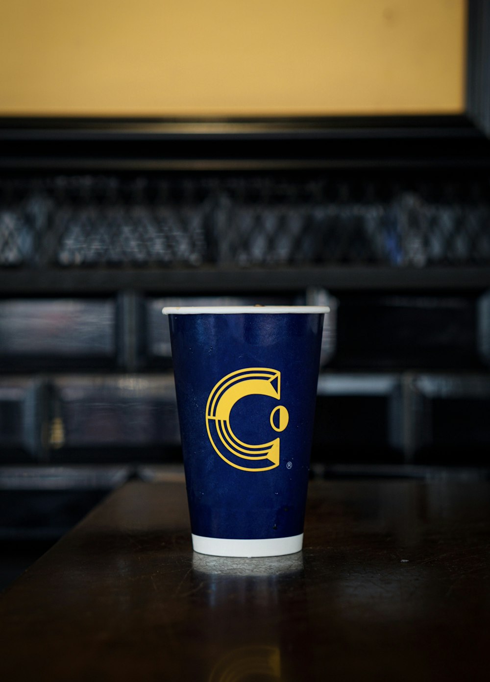 a cup sitting on top of a wooden table