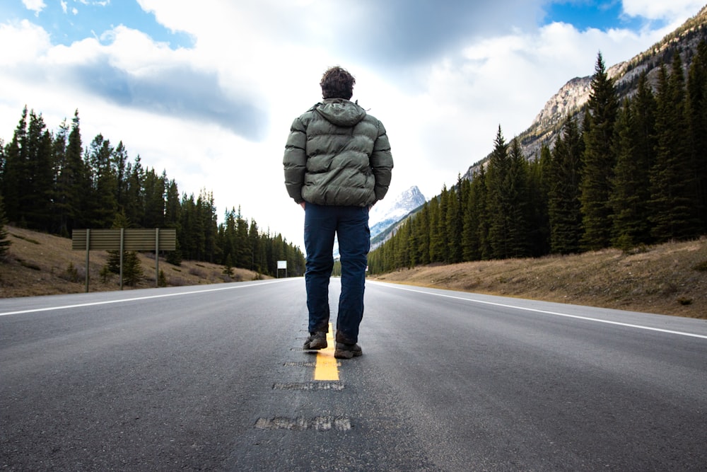 man walking on road