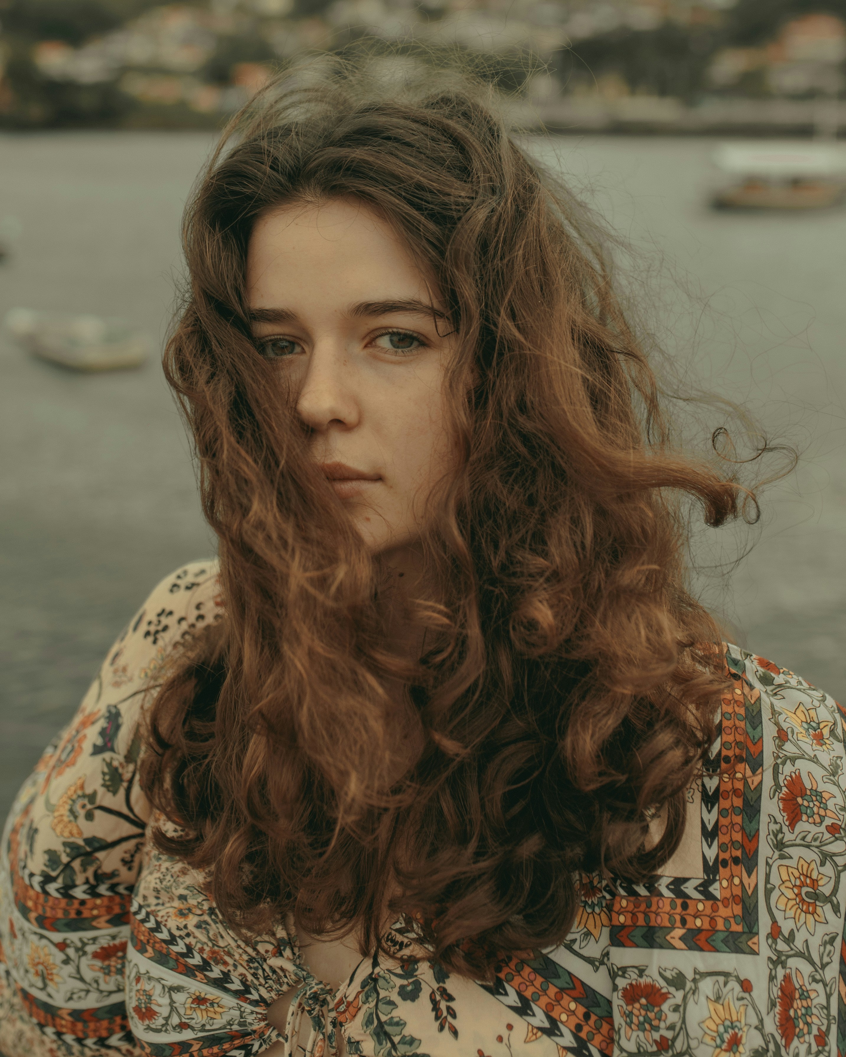 woman in white and orange floral top