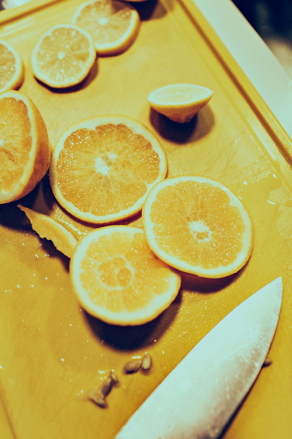 sliced lemon near gray stainless steel knife