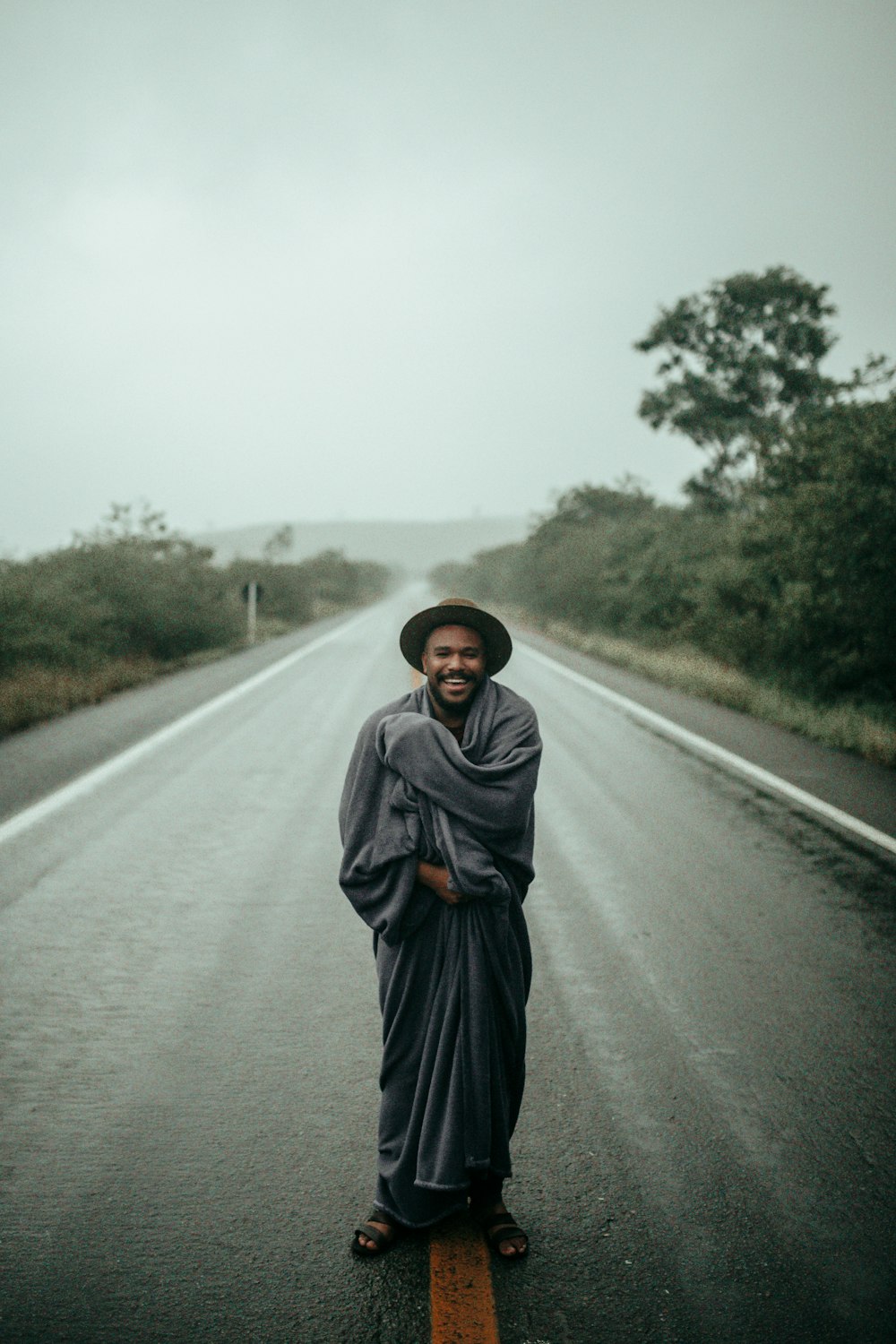 man standing on road during daytime