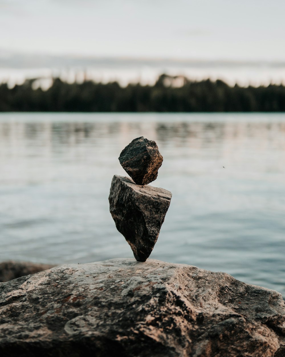 closeup photo of twp stones near body of water