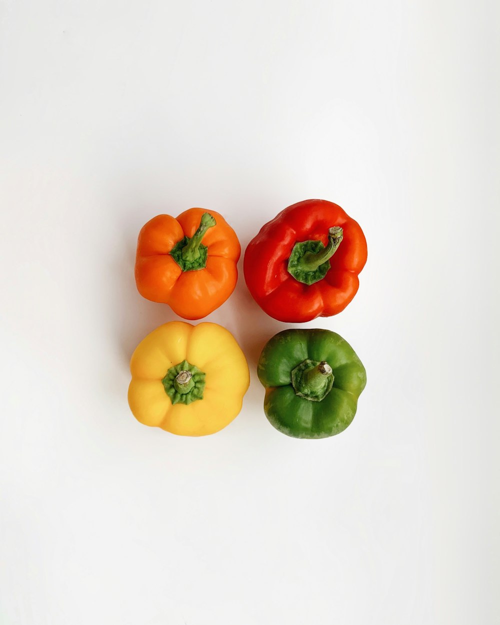 four assorted-colored bell peppers
