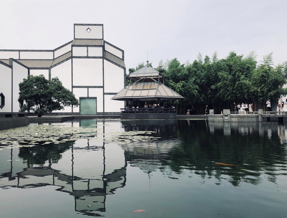 brown and grey gazebo across pond