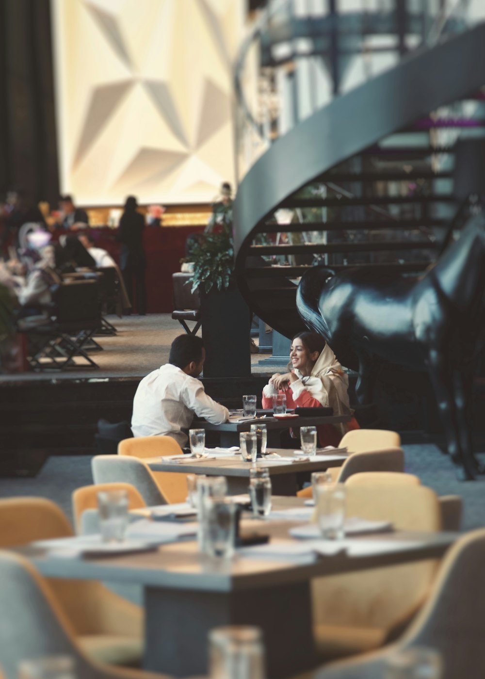 a couple of people sitting at a table in a restaurant