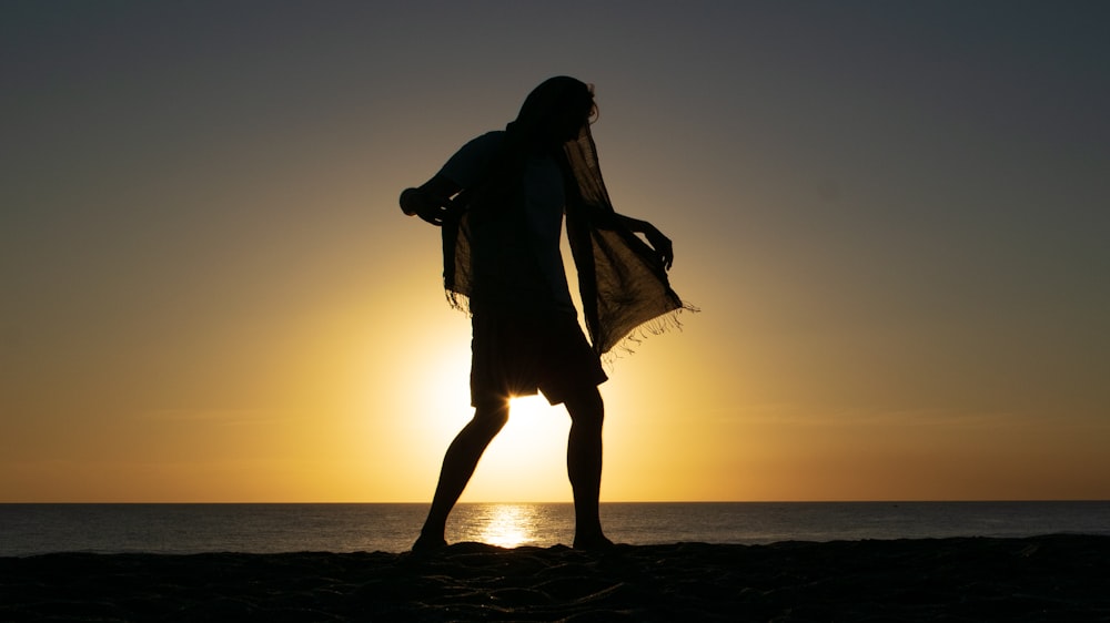 silhouette photo of person wearing black scarf